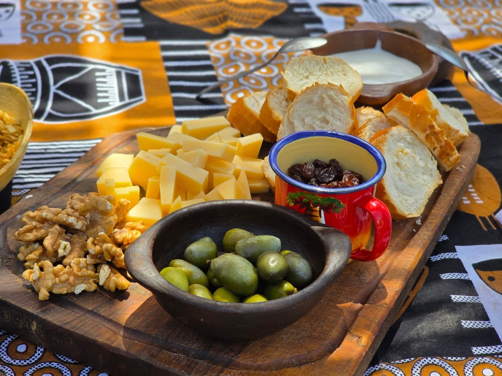 Ahşap tahtada zeytin, peynir, ekmek ve ceviz